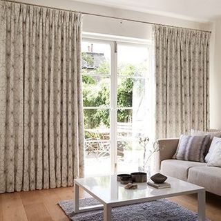 Living room setting with sliding patio doors dressed with Lavida Grey Curtains