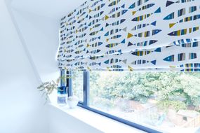 Bathroom with fish print roman blind