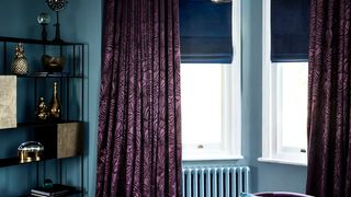 Radiance Midnight Roman blinds with Broadleigh Aubergine curtains hung in an opulent living room