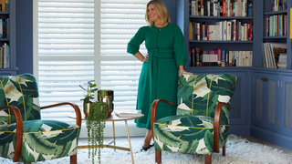 Erica Davies in front of white shutters