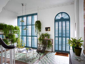 Blue custom colour shaped shutters in hallway