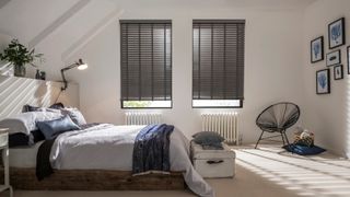 Bedroom with two windows fitted with Wooden blinds in Lunarre Faux Wood