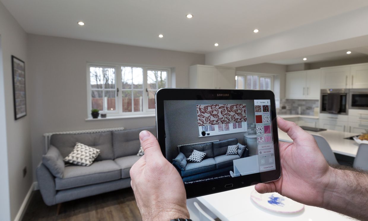 Customer using visualisation app to compare blinds in living room window