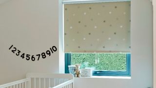 Patterned Twinke Stars Beige roller blind hung in nursery