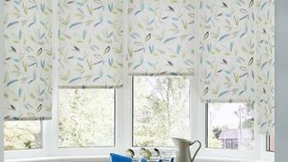 Floral patterned Joya Yellow roller blinds hung in dining room