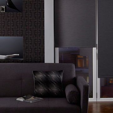 Plain dark Jericho Charcoal roller blinds hung in living room
