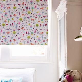 Forest-patterned Woodland Pink roller blind hung in child's room