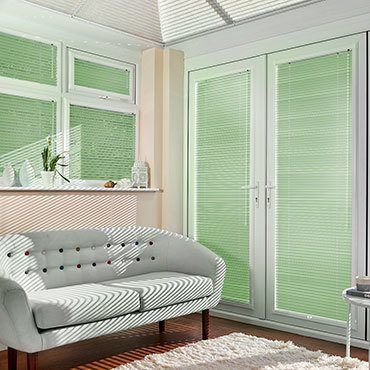 Green Portfolio Pistachio Venetian blinds hanging in patio doors