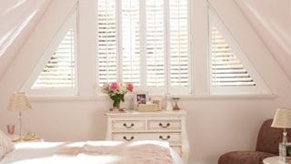 White shaped shutters in a roof conversion window - Silk White Warwick shutters