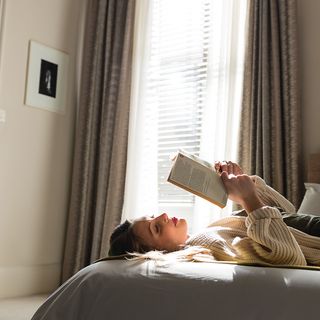 Lifestyle shot featuring white faux wood blinds