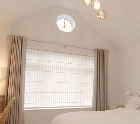 Bedroom with Roman Blinds layered with Eyelet Curtains in neutral tones
