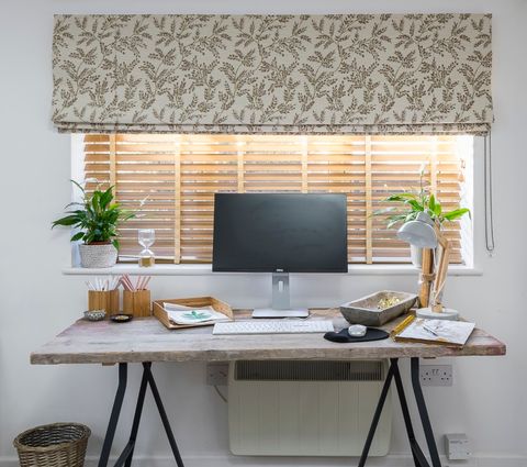 Liz Earle's home office with oakwood faux wooden blinds behind a small desk and computer