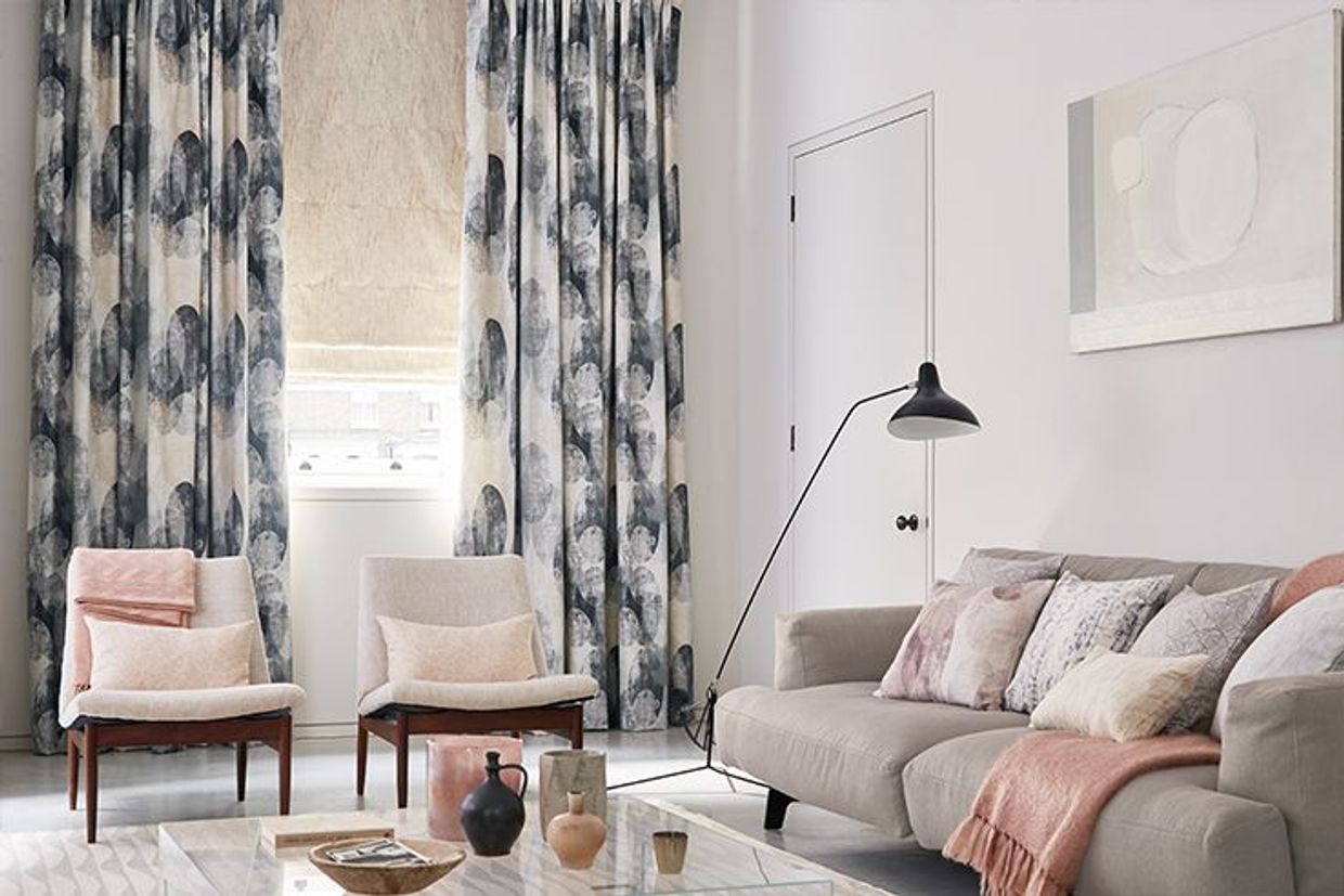 Minimalist living room with pastel decor and patterned blue curtains