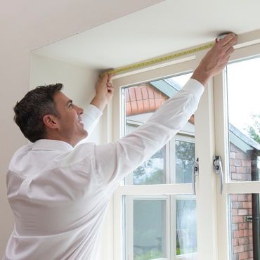 Hillarys advisor measuring a window ready for an expert fitting