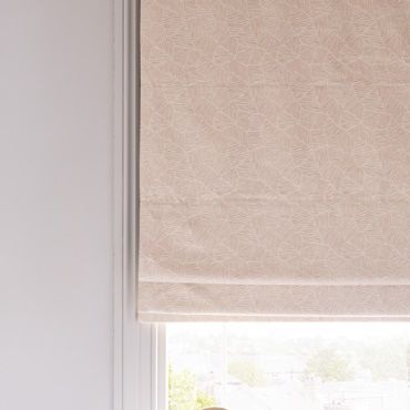 Light pink roman blind close up