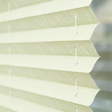 close up of green pleated blinds