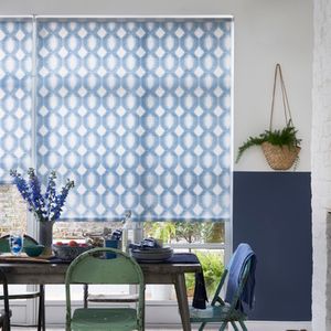 Groovy geometric printed blue and white roller blinds in a dining room