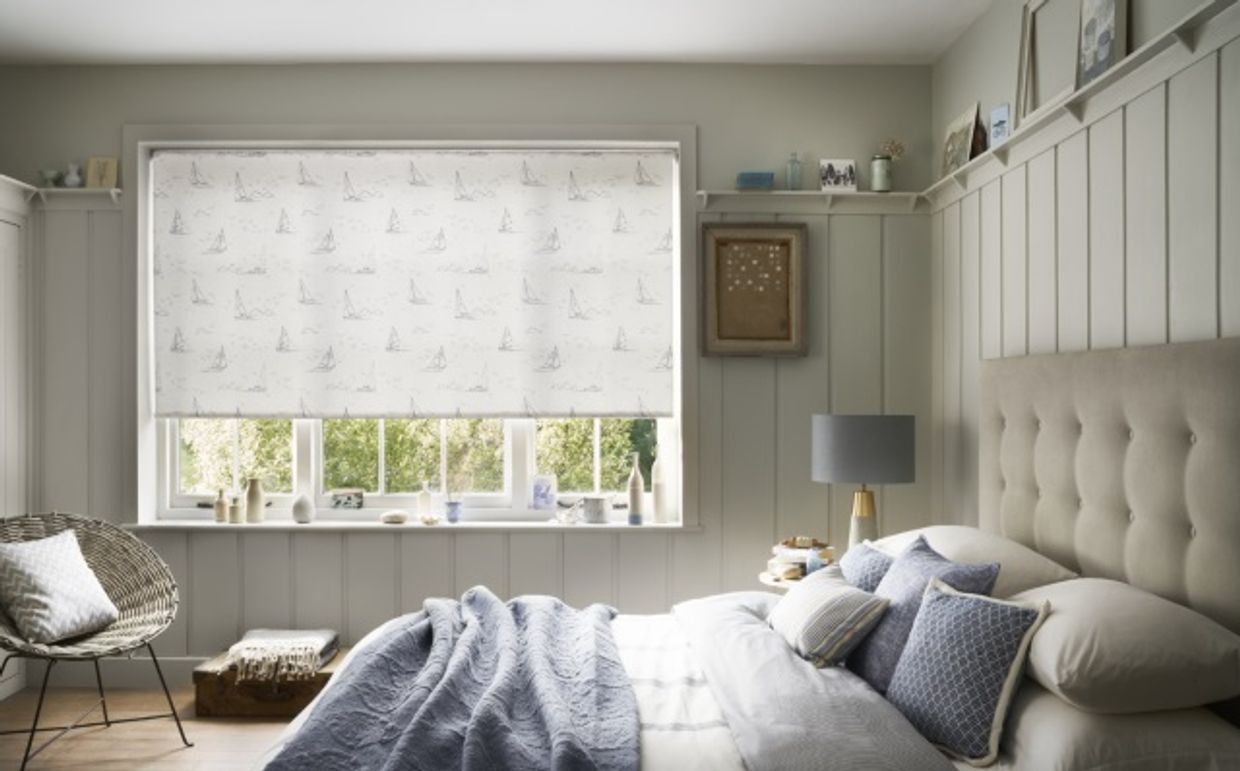 bedroom with white coastal style roller blinds with boat printed pattern