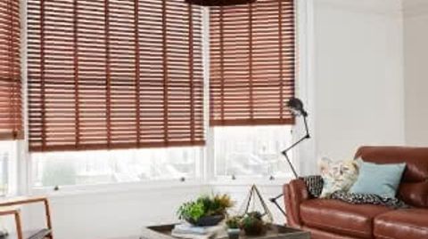 Living room with furniture and wooden blinds