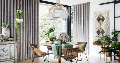Grey wave header curtains over a patio door in a contemporary dining room