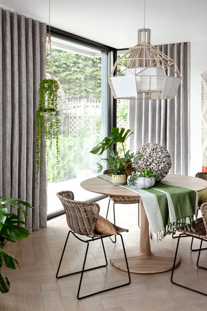 Echo Zinc curtains hanging in a dining room filled with plants