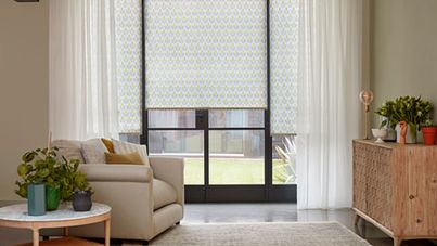 Crittall doors with Voile curtains layered over a floral Roller blind