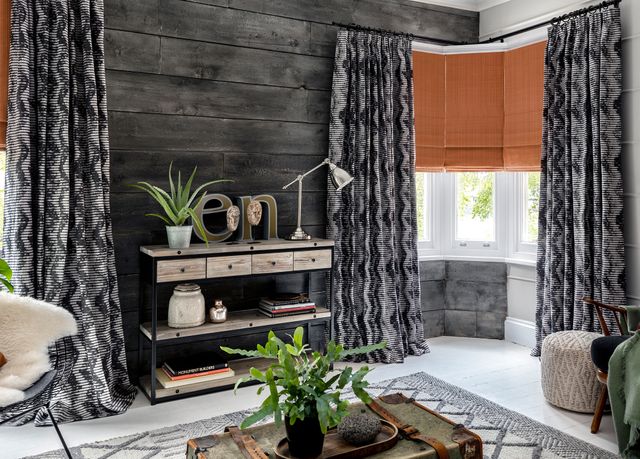 Curtain in Cadillac Noir and Roman blind in Clarence Terracotta hanging in a living room