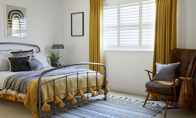 Silk white shutters and Tetbury Mustard curtains in bedroom