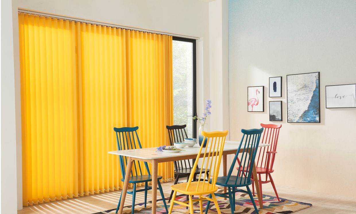 Acacia Yellow Vertical blinds hanging in a dining room