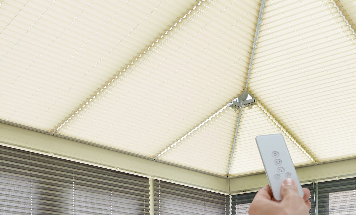 Crush charcoal metopleat blinds in conservatory