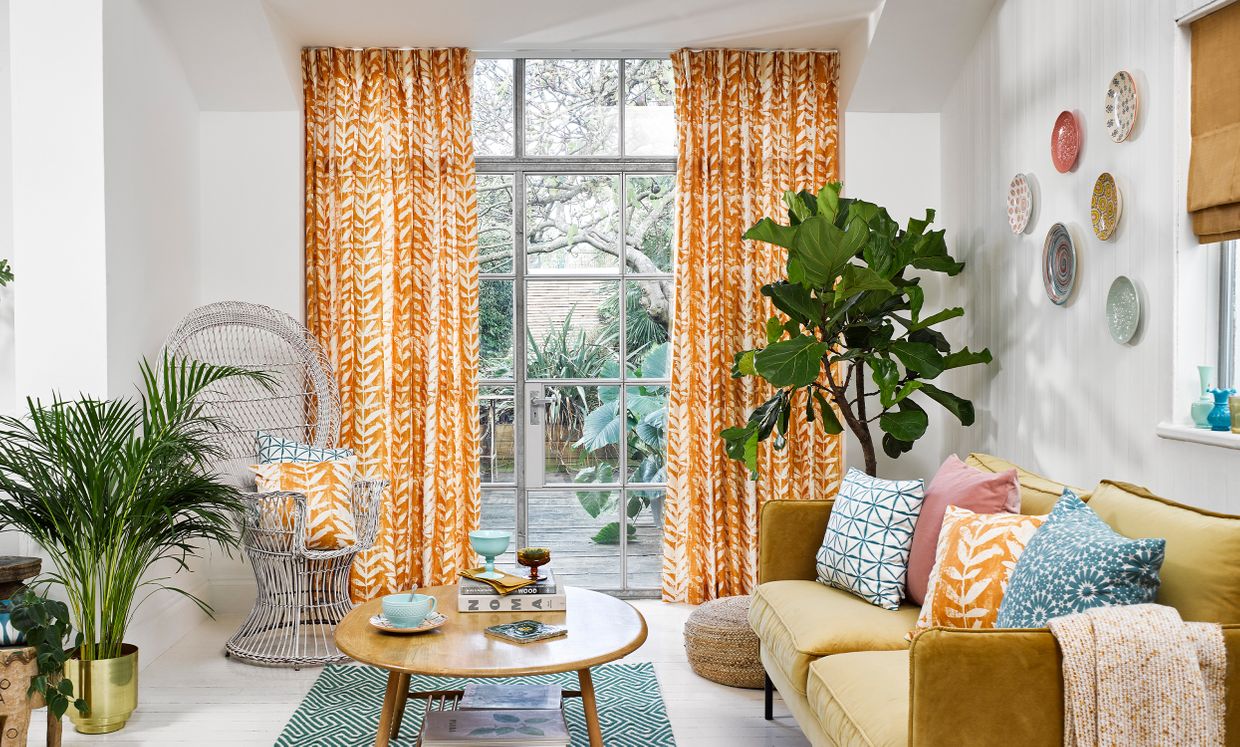 Statement Living Room with Orange Pinch Pleat Curtains in Isra Amber and Colourful Decor
