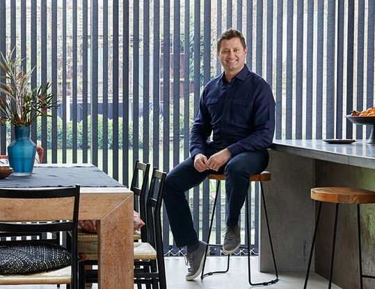George Clarke in front of Norfolk Charcoal vertical blind