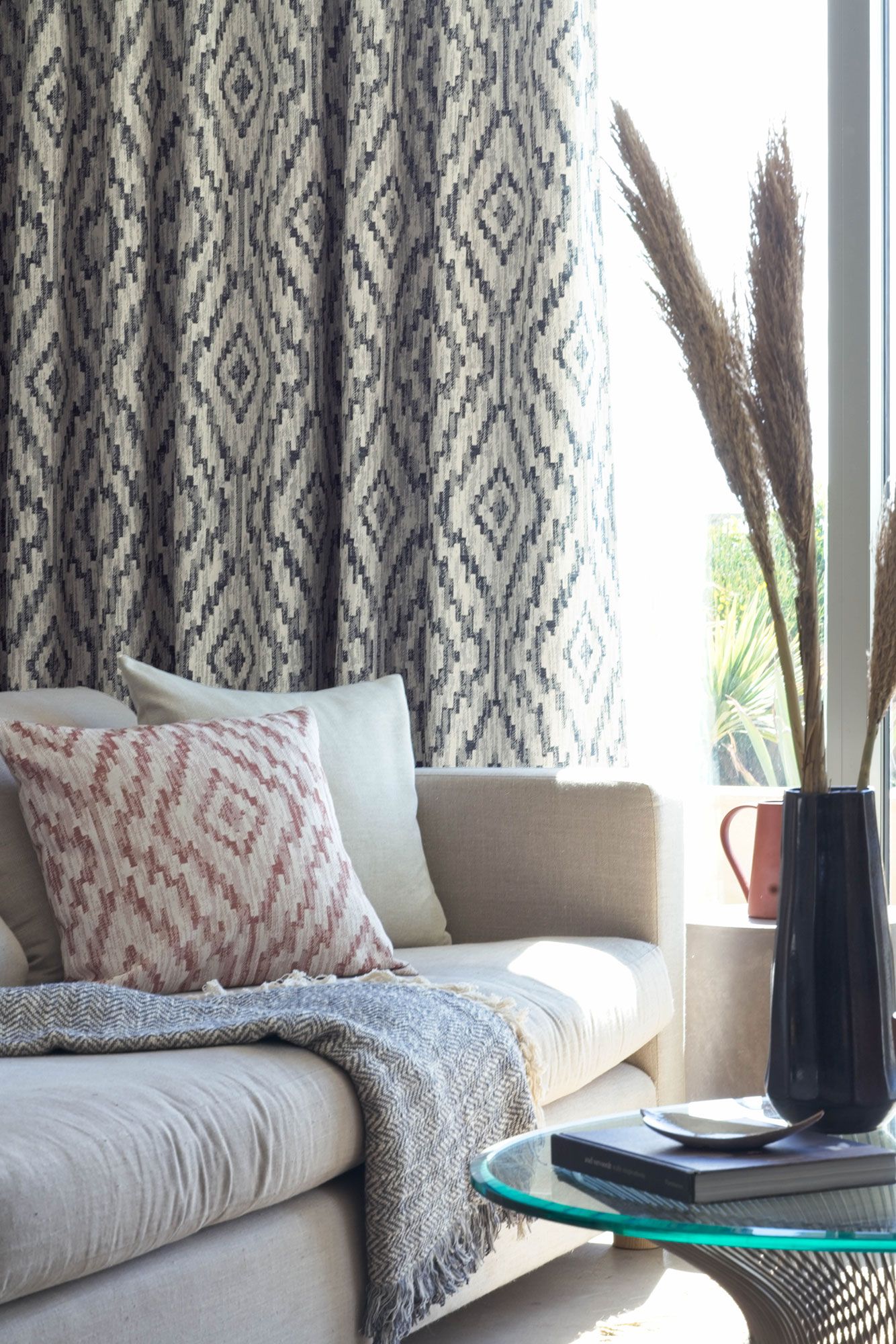Close up detail of sofa with geometric print curtains