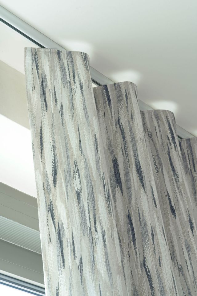 Close up detail of Impression Smoke curtains with a wave header style