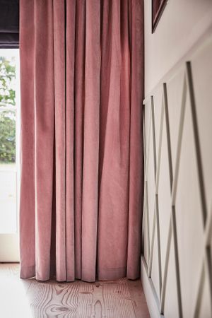 Malone Rose curtains and Allure Midnight romans in living room