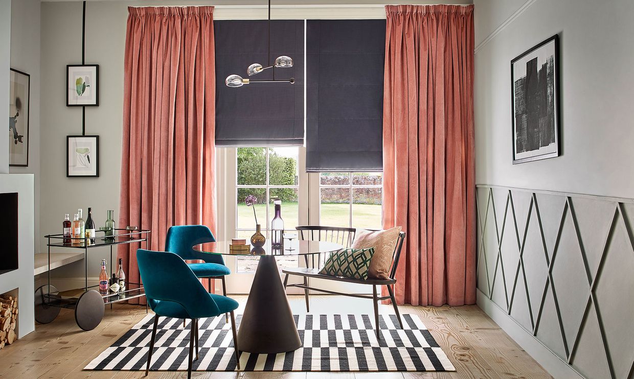 Dining room with French doors dressed with velvet curtains and Roman blinds