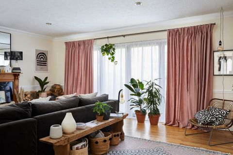 Living room with large sliding doors dressed in voiles and curtains