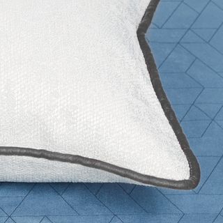 White coloured cushion with grey coloured edge piping