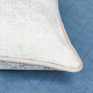 BWhite coloured cushion with cream coloured edge piping
