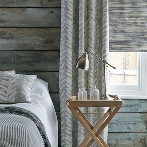 Grey Patterned Blackout Curtains in Isra Dove Fabric with a Grey Riviera Dusk Roman blind in the bedroom