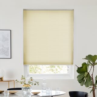 Creamy pearl pleated blind dressed on window