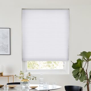 White pleated blind dressed on window