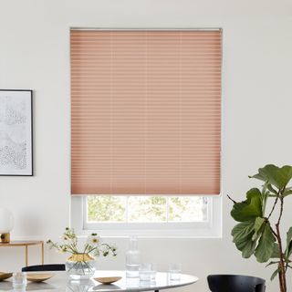 Pink blush pleated blind dressed on window
