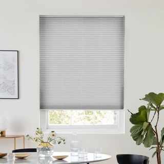 Grey pleated blind dressed on window