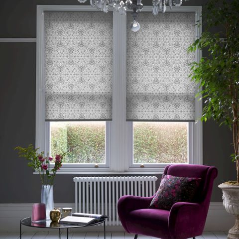 rich purple arm chair in a moody, luxe dark grey room with grey patterned modern looking roller blinds