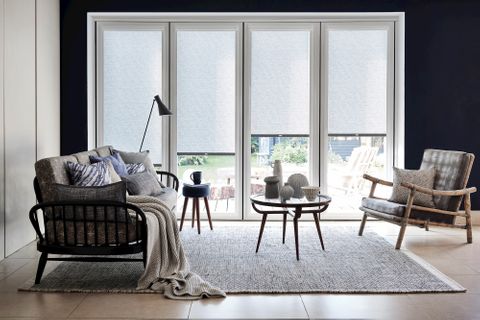 Monochrome living room with a grey blind and wooden furnishings
