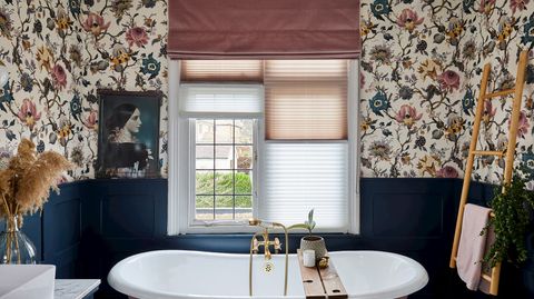 Rose pink, velvet roman blind over light, pleated blinds in a floral bathroom with rose pink and navy accents