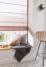 Serenity powder pink voile roman blind against reading nook window with book and blanket