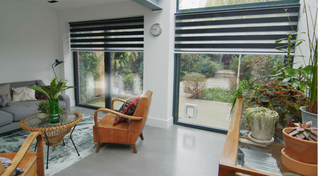Wide windows covered by Dawn Black day and night blinds.