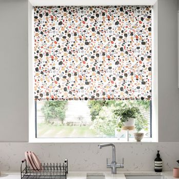 Multicoloured and pebble decorated roller blind fitted to a kitchen window 